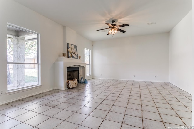 unfurnished living room with ceiling fan, plenty of natural light, and light tile patterned flooring