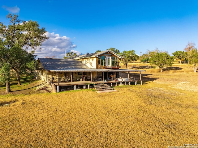 rear view of house featuring a lawn