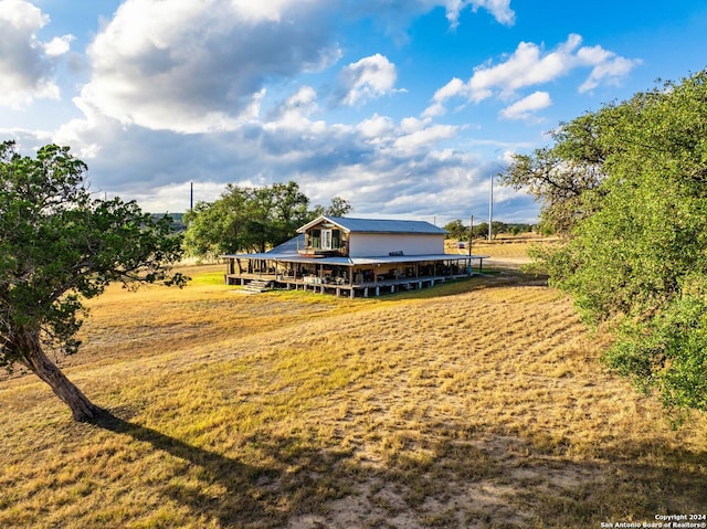 view of yard with a wooden deck and a rural view