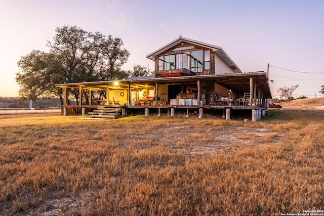 view of front of home with a lawn and a porch