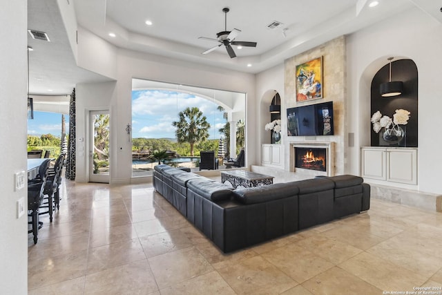 living area featuring built in shelves, recessed lighting, visible vents, and a fireplace