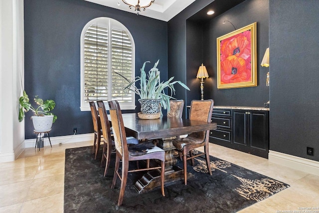 dining area with baseboards and light tile patterned floors