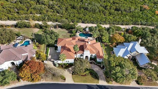 aerial view featuring a wooded view