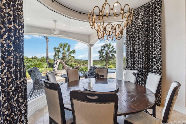 dining space with a notable chandelier, ornate columns, and light tile patterned floors