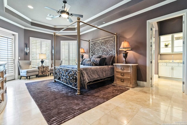 bedroom featuring visible vents, baseboards, ornamental molding, a tray ceiling, and light tile patterned flooring