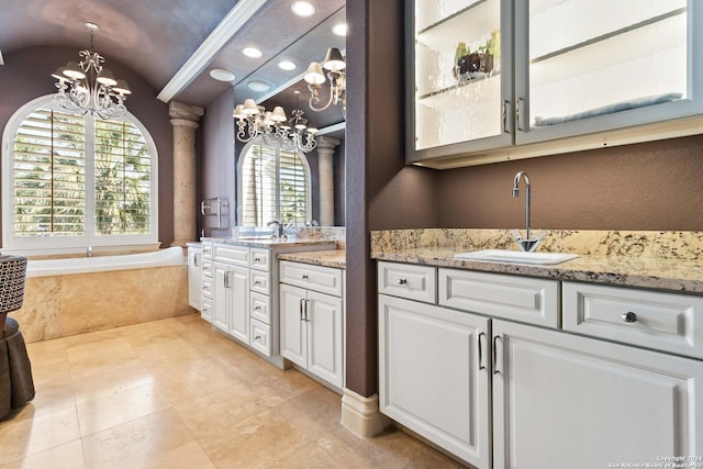 full bathroom featuring a bath, lofted ceiling, vanity, and a chandelier