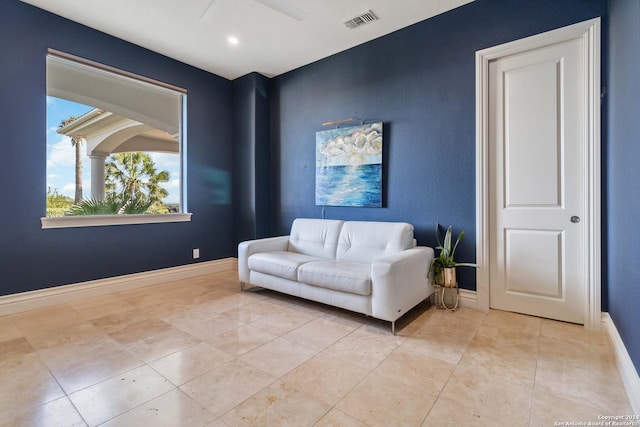 sitting room with baseboards, visible vents, ceiling fan, and light tile patterned flooring