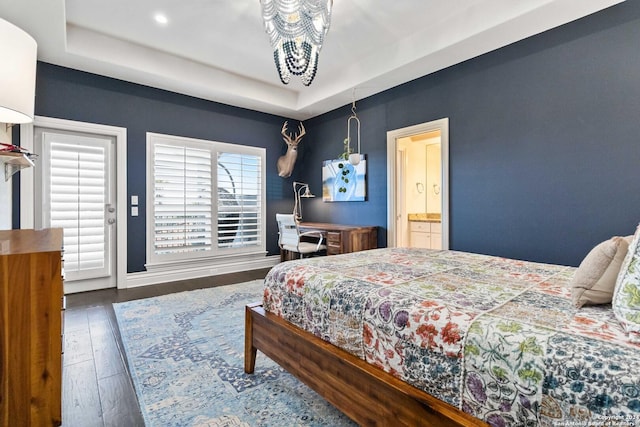 bedroom with dark wood-type flooring and a raised ceiling