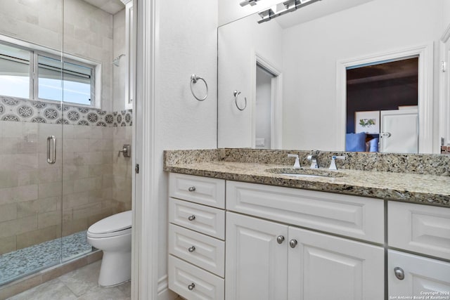 bathroom featuring toilet, a stall shower, tile patterned flooring, and vanity