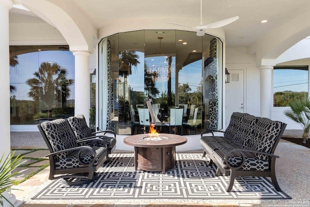 view of patio / terrace with a fire pit and a ceiling fan