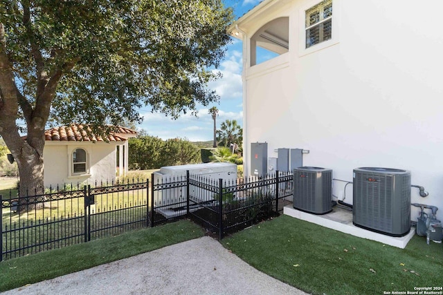 exterior space featuring fence private yard and central air condition unit