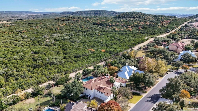 birds eye view of property with a view of trees