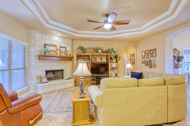 living room featuring a tray ceiling and a wealth of natural light