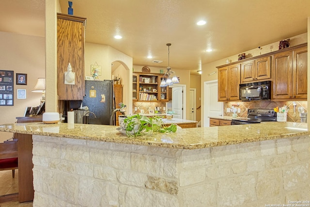 kitchen with tasteful backsplash, light stone countertops, kitchen peninsula, and black appliances