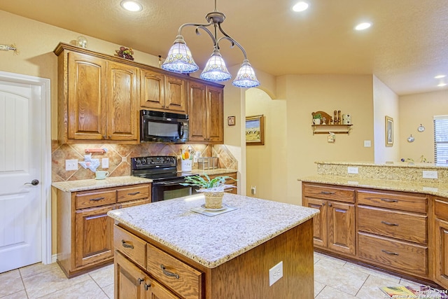 kitchen with light stone countertops, black appliances, pendant lighting, light tile patterned floors, and a kitchen island