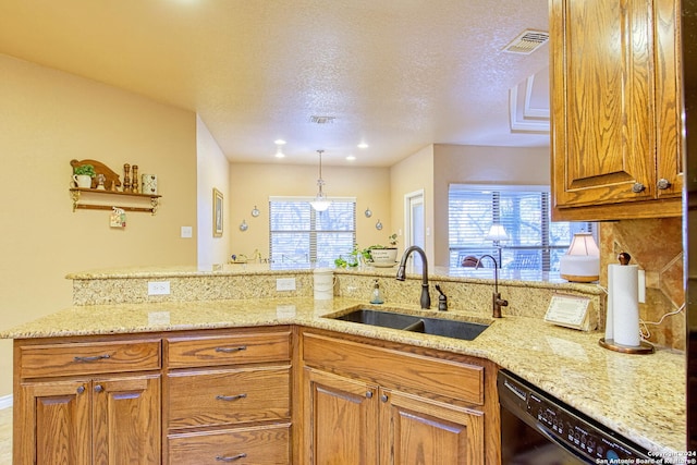 kitchen featuring light stone countertops, black dishwasher, sink, and kitchen peninsula