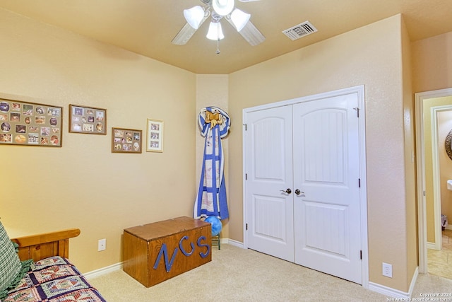 carpeted bedroom with a closet and ceiling fan