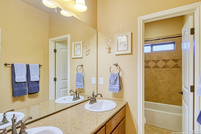 bathroom featuring vanity and tiled shower / bath combo