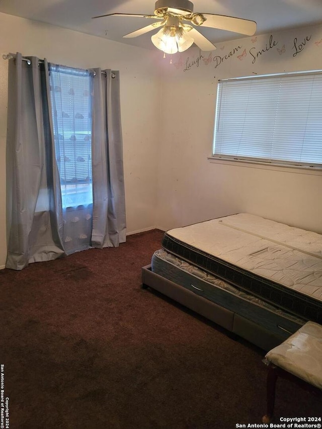 unfurnished bedroom featuring carpet and ceiling fan