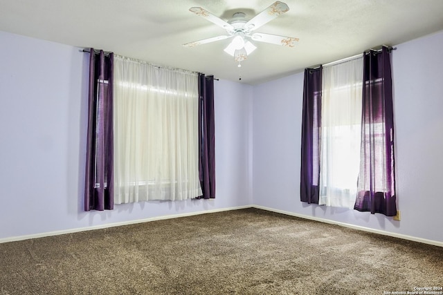 empty room featuring ceiling fan and carpet floors