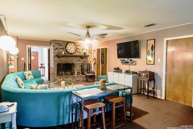 living room featuring ceiling fan, carpet, and a brick fireplace