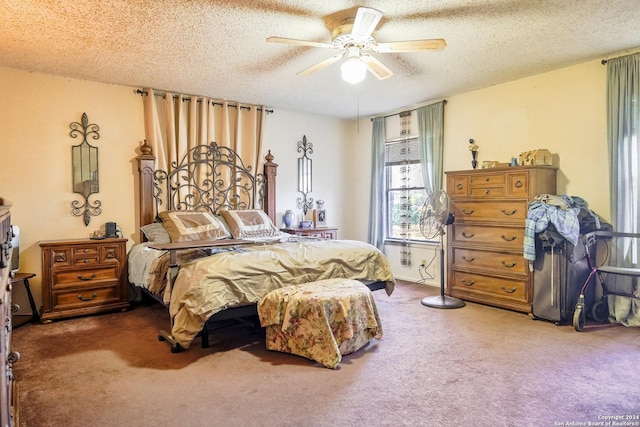 carpeted bedroom featuring ceiling fan and a textured ceiling