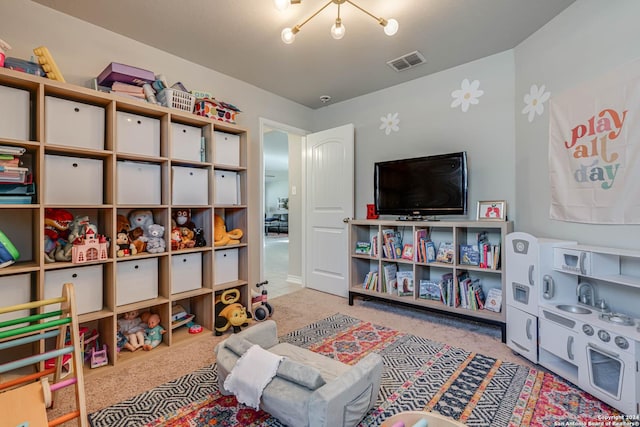 game room with a notable chandelier and light carpet