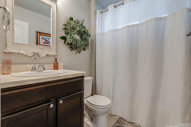 bathroom featuring tile patterned flooring, vanity, and toilet