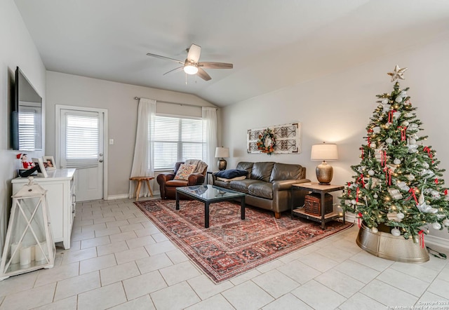 tiled living room with ceiling fan and vaulted ceiling