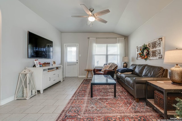 living room featuring ceiling fan, light tile patterned flooring, and vaulted ceiling