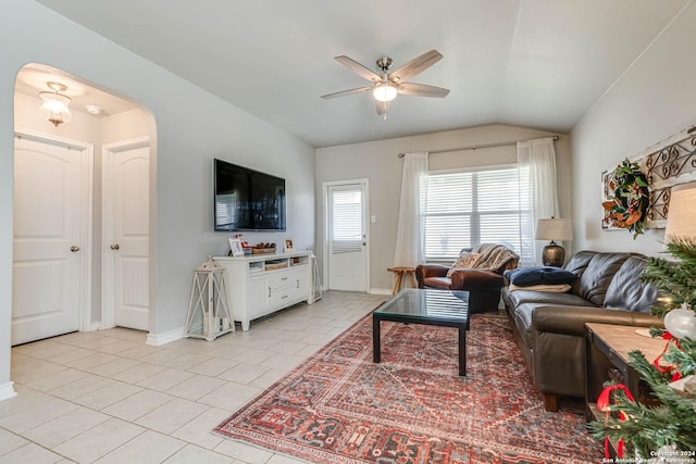 living room with ceiling fan, light tile patterned floors, and lofted ceiling