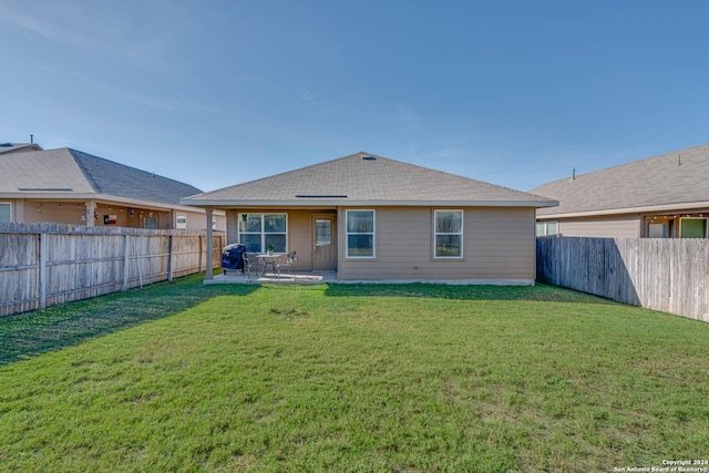 back of property featuring a yard and a patio