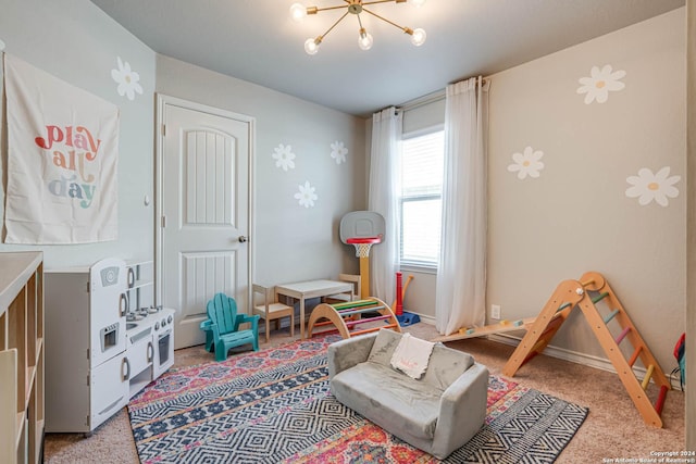 rec room featuring light colored carpet and an inviting chandelier