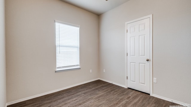 empty room featuring dark hardwood / wood-style flooring