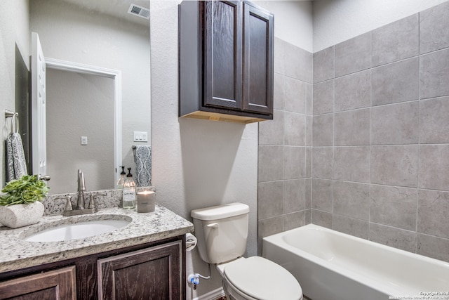 full bathroom featuring vanity, toilet, and tiled shower / bath combo