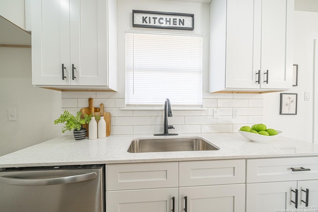 kitchen featuring backsplash, white cabinets, light stone counters, sink, and dishwasher