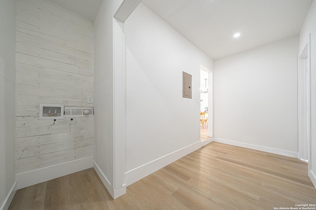 corridor featuring light wood-type flooring and electric panel