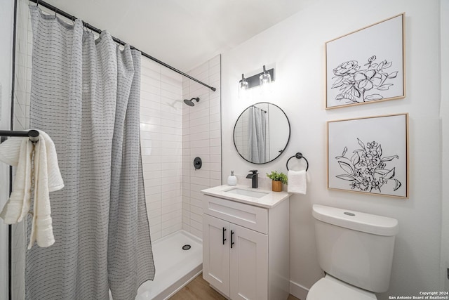 bathroom with toilet, vanity, and a shower with shower curtain