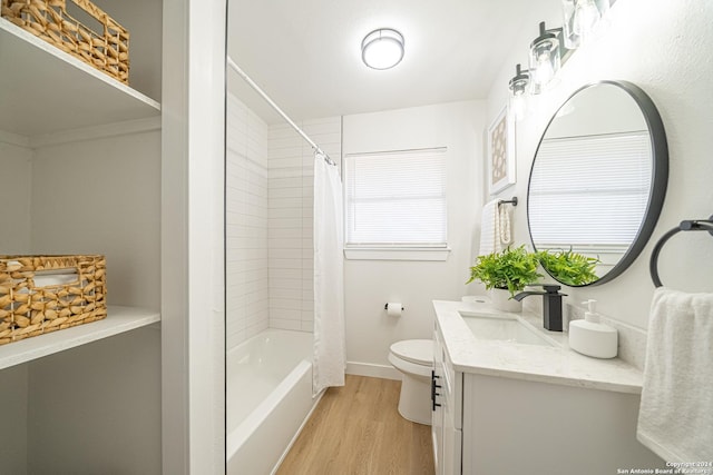 full bathroom with hardwood / wood-style floors, vanity, toilet, and shower / bath combo with shower curtain