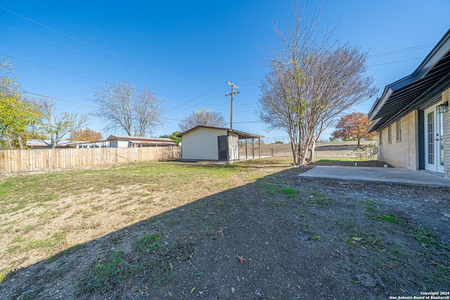 view of yard with an outbuilding and a patio