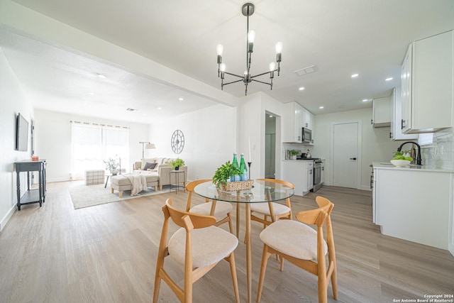 dining room featuring a chandelier and light hardwood / wood-style flooring