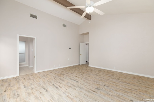 empty room featuring ceiling fan, high vaulted ceiling, and light hardwood / wood-style flooring