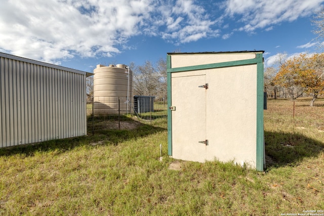 view of outbuilding featuring a lawn