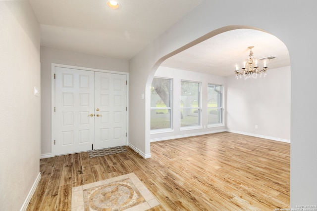 entryway featuring a notable chandelier and hardwood / wood-style flooring