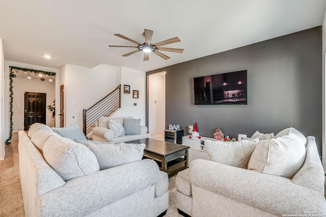 carpeted living room with ceiling fan