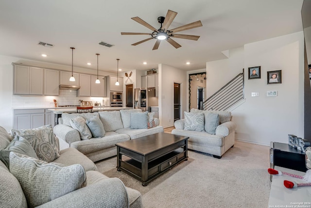 living room with light carpet and ceiling fan