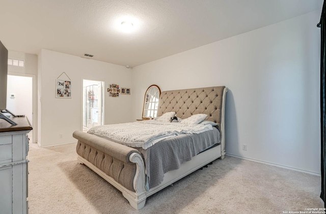 carpeted bedroom with a textured ceiling