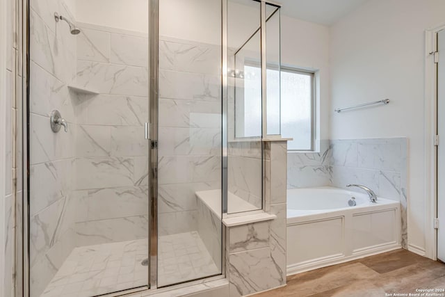 bathroom featuring separate shower and tub and hardwood / wood-style flooring