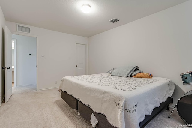 bedroom featuring light colored carpet