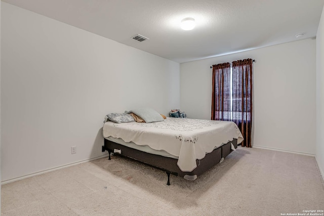 bedroom featuring light carpet